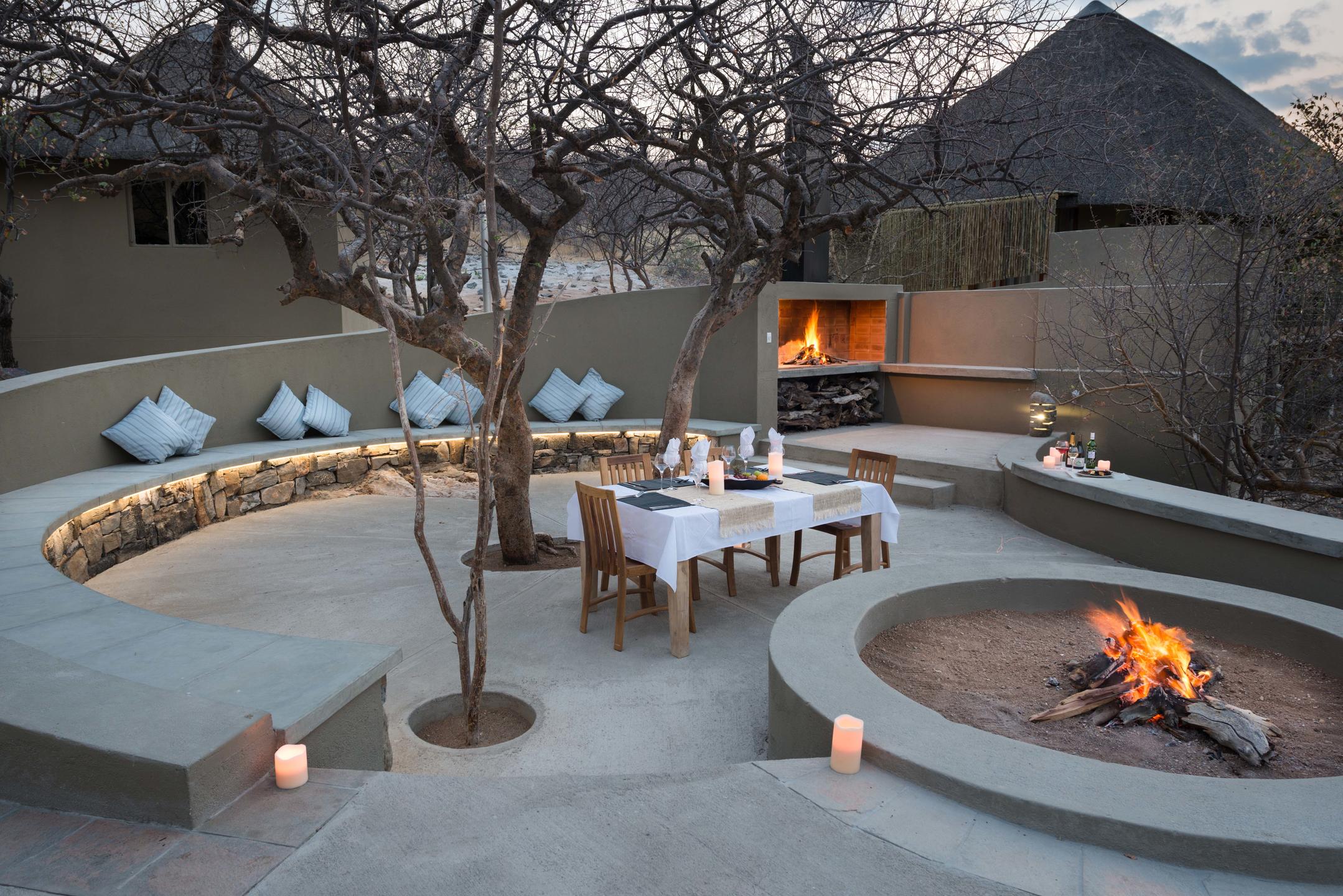 Thatched contemporary main structures of Safarihoek on the hill